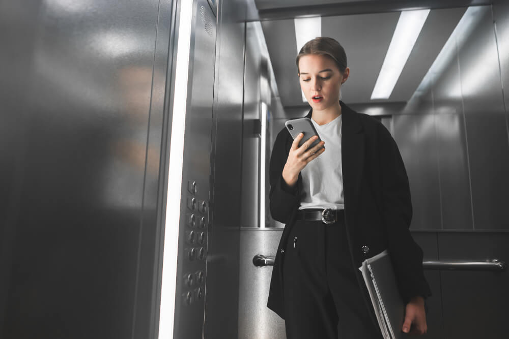 Woman in elevator on cell phone